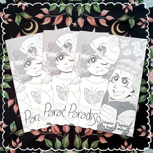 Photo of 3 copies of the Paradiso Chapter 2 Sampler. It features the characters Tiffany and Connor on the cover. It's in black and white greyscale with screen tones.