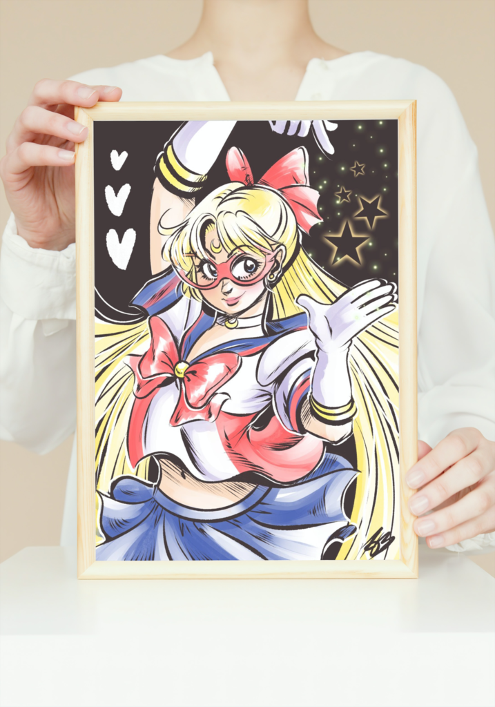 The aforementioned Sailor V illustration in a mock up frame that's being held by a white women whose head is out of the shot.